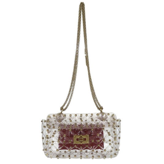 Clear handbag with gold chain strap and red interior on a white background