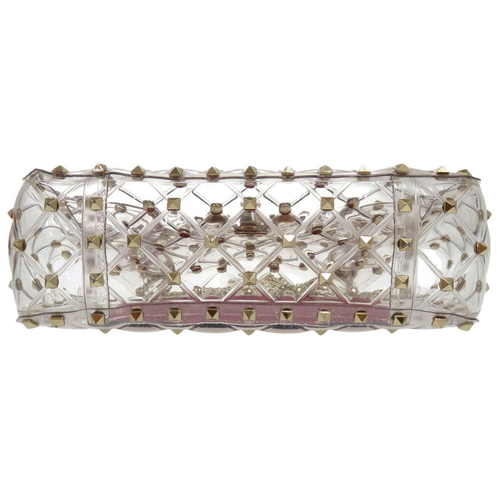 Clear crystal clutch with gold studs on a white background
