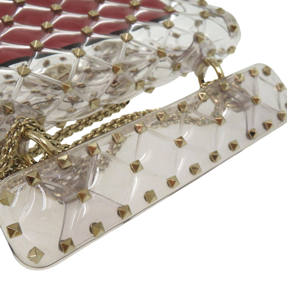 Clear handbag with gold studs and chain detail on a white background