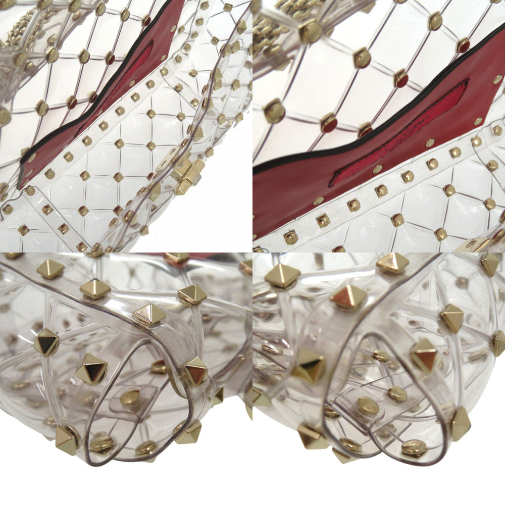 Clear high-heeled shoes with gold studs on a white background
