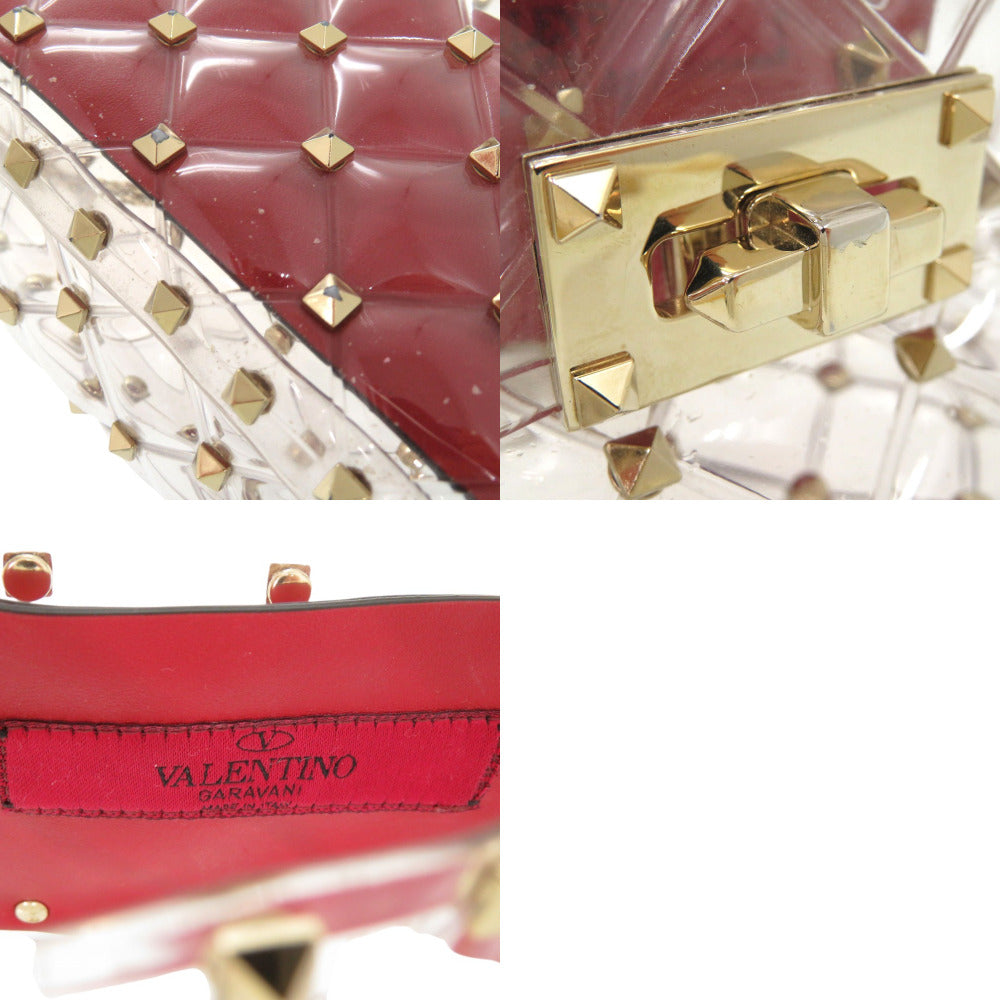 Red handbag with gold studs and a gold lock, featuring the Valentino logo.