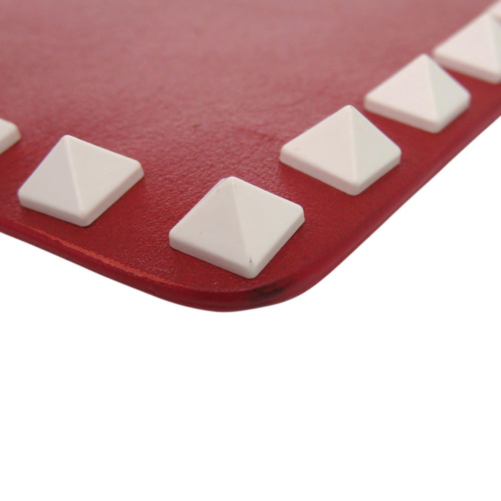 Red mat with white pyramid-shaped textured grips on a white background