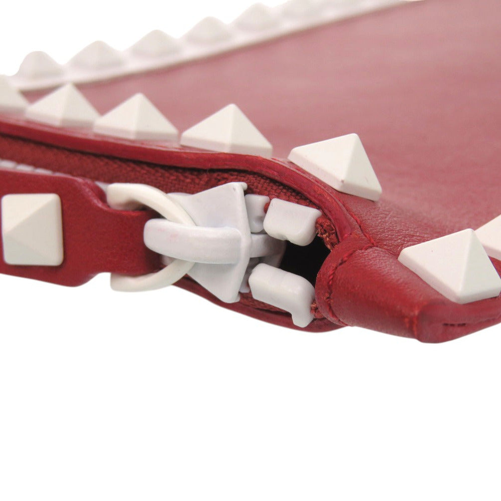 Red leather product with white pyramid studs on a white background