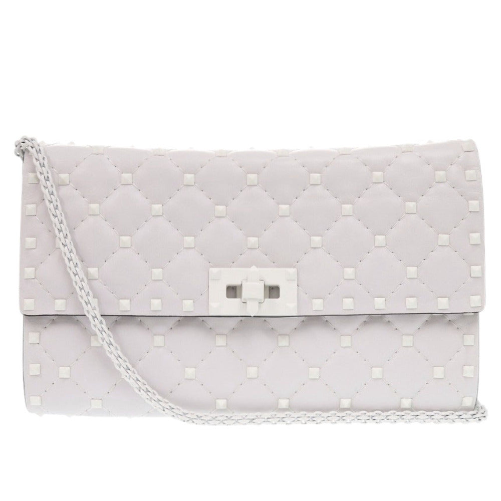 Quilted clutch bag with a chain strap on a white background