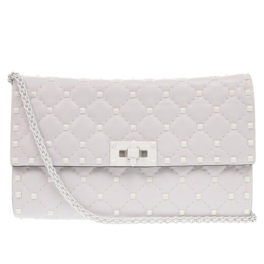 Quilted clutch bag with a chain strap on a white background