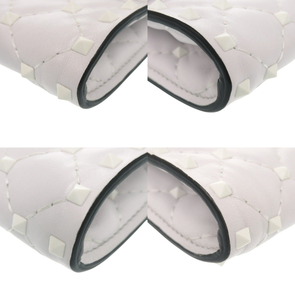 White quilted product with black trim on a white background