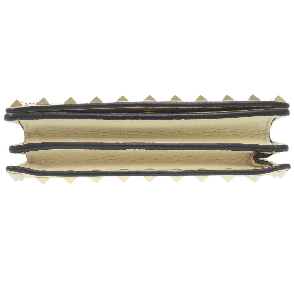 Beige and black rubber strip with teeth on a white background