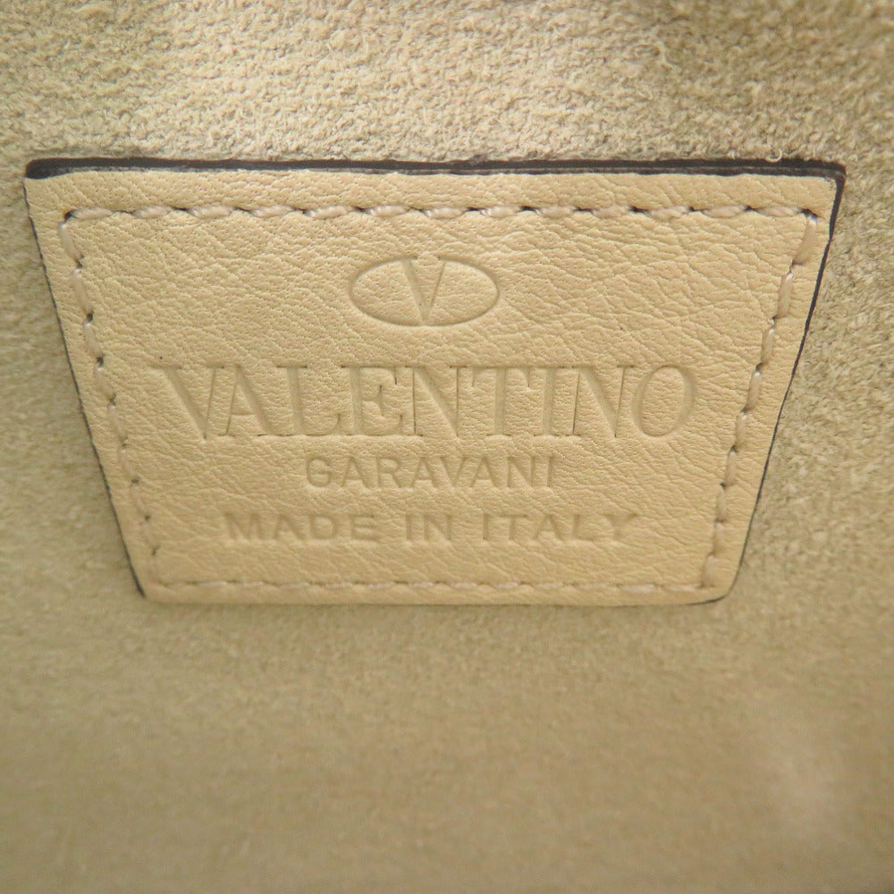 Valentino Garavani label on a beige leather surface