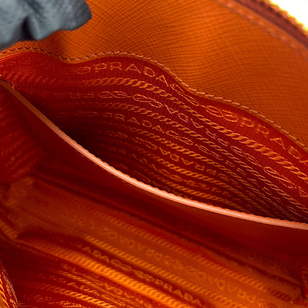 Close-up of Prada handbag with visible branding and texture.