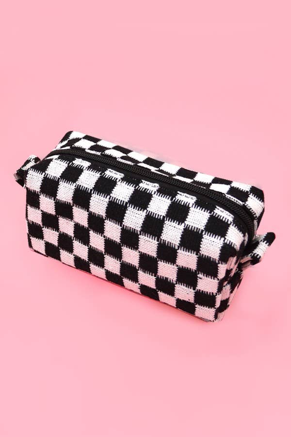 Black and white checkered pouch on a pink background