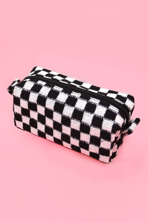 Black and white checkered pouch on a pink background
