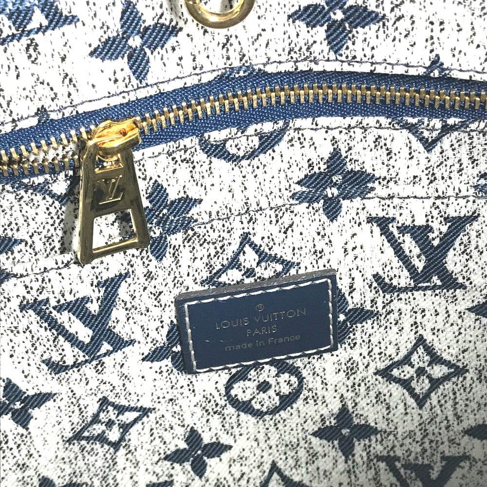 Close-up of a Louis Vuitton bag with monogram pattern and gold zipper.