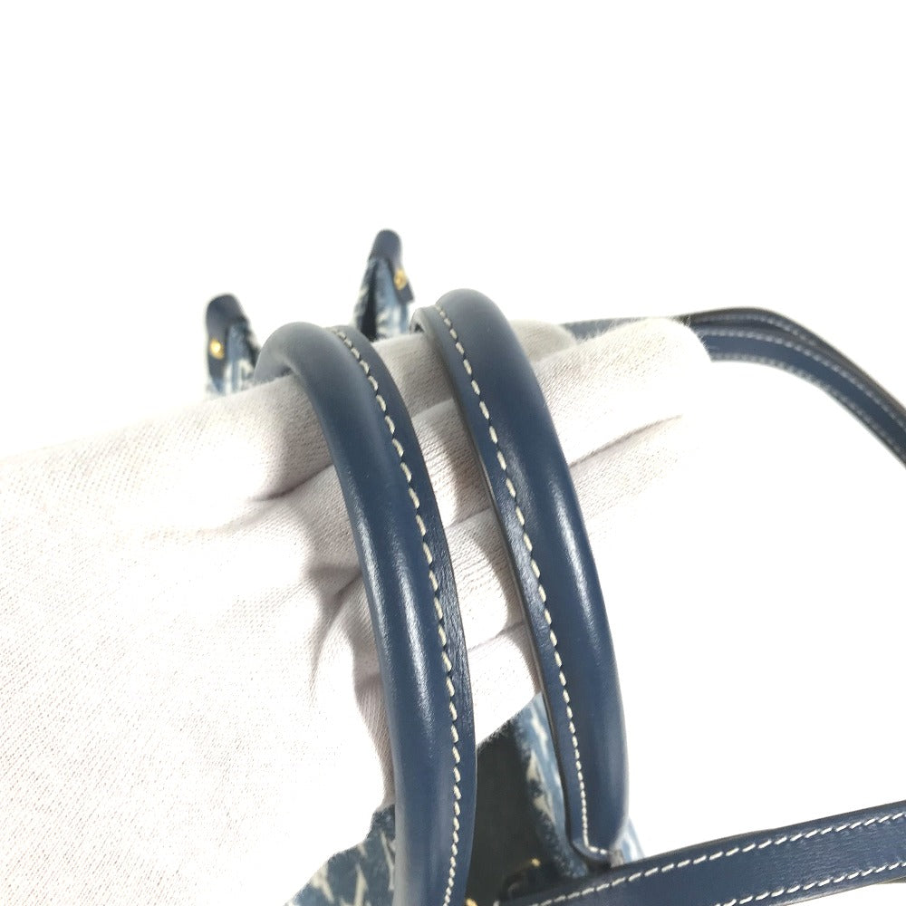 Close-up of blue leather straps with white stitching on a beige background