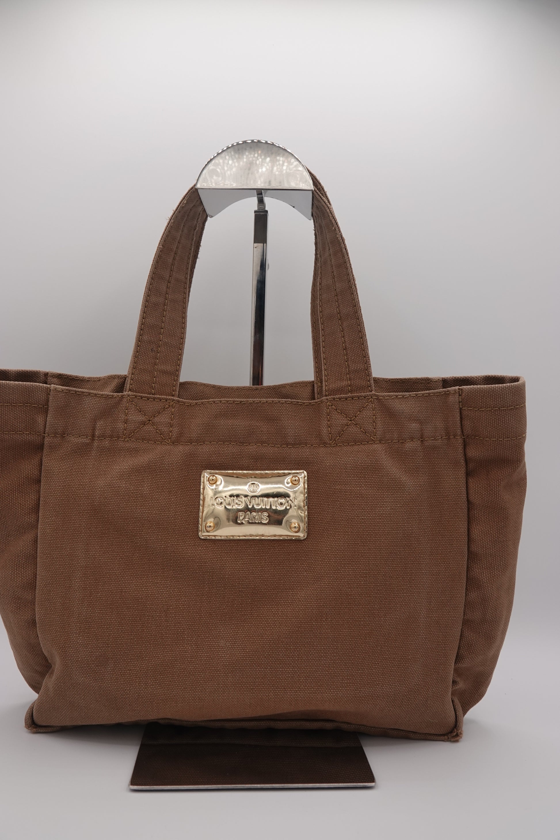 Brown bag with a gold emblem on a white background