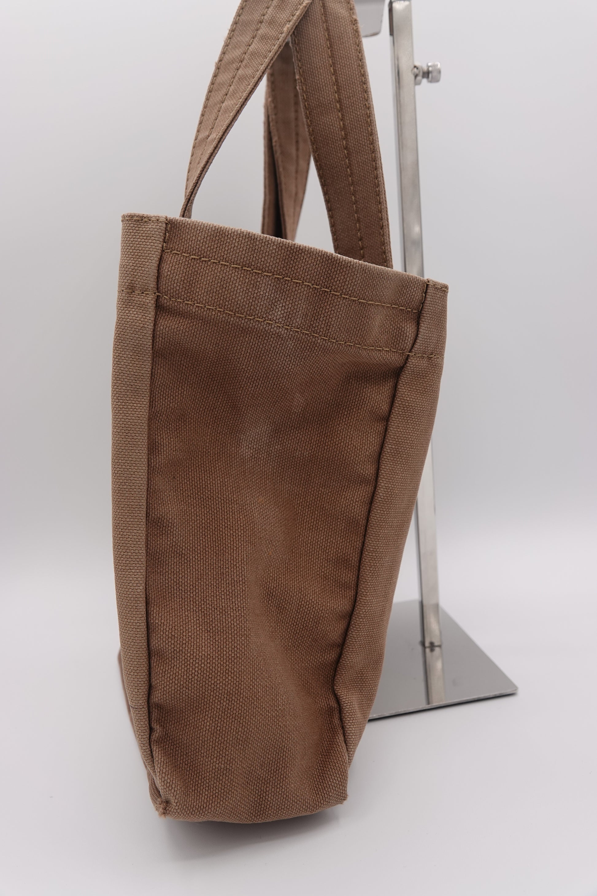 Brown fabric bag with a strap on a white background