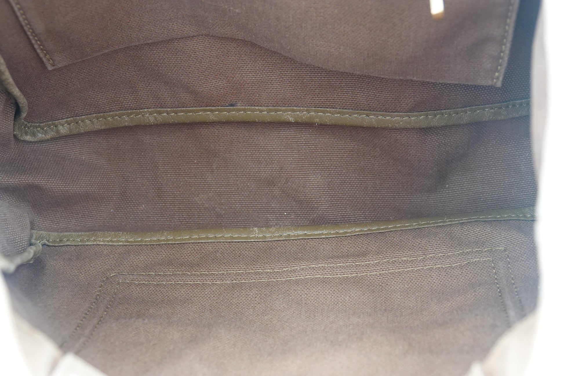 Close-up of a brown fabric surface with stitching details
