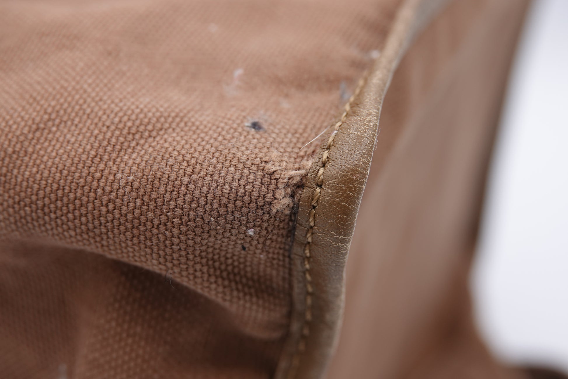 Close-up of brown fabric with visible stitching and texture