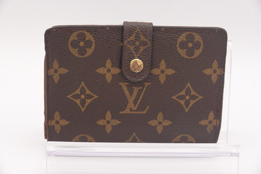 Brown wallet with gold monogram pattern on a white background