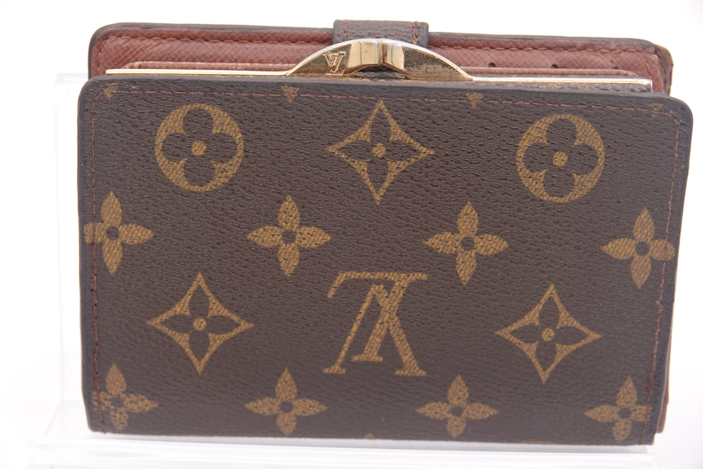 Brown wallet with gold monogram pattern on a white background