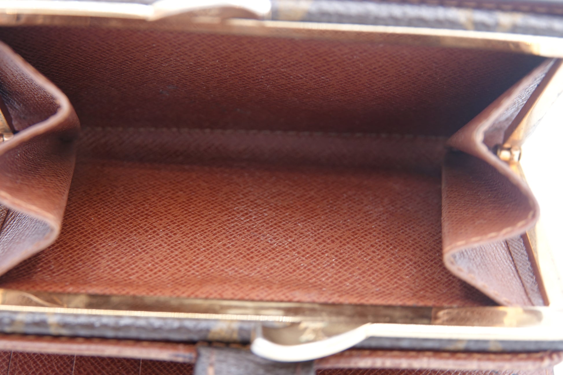 Close-up of a brown textured bag with visible stitching details.