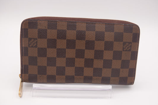 Brown checkered wallet on a white background