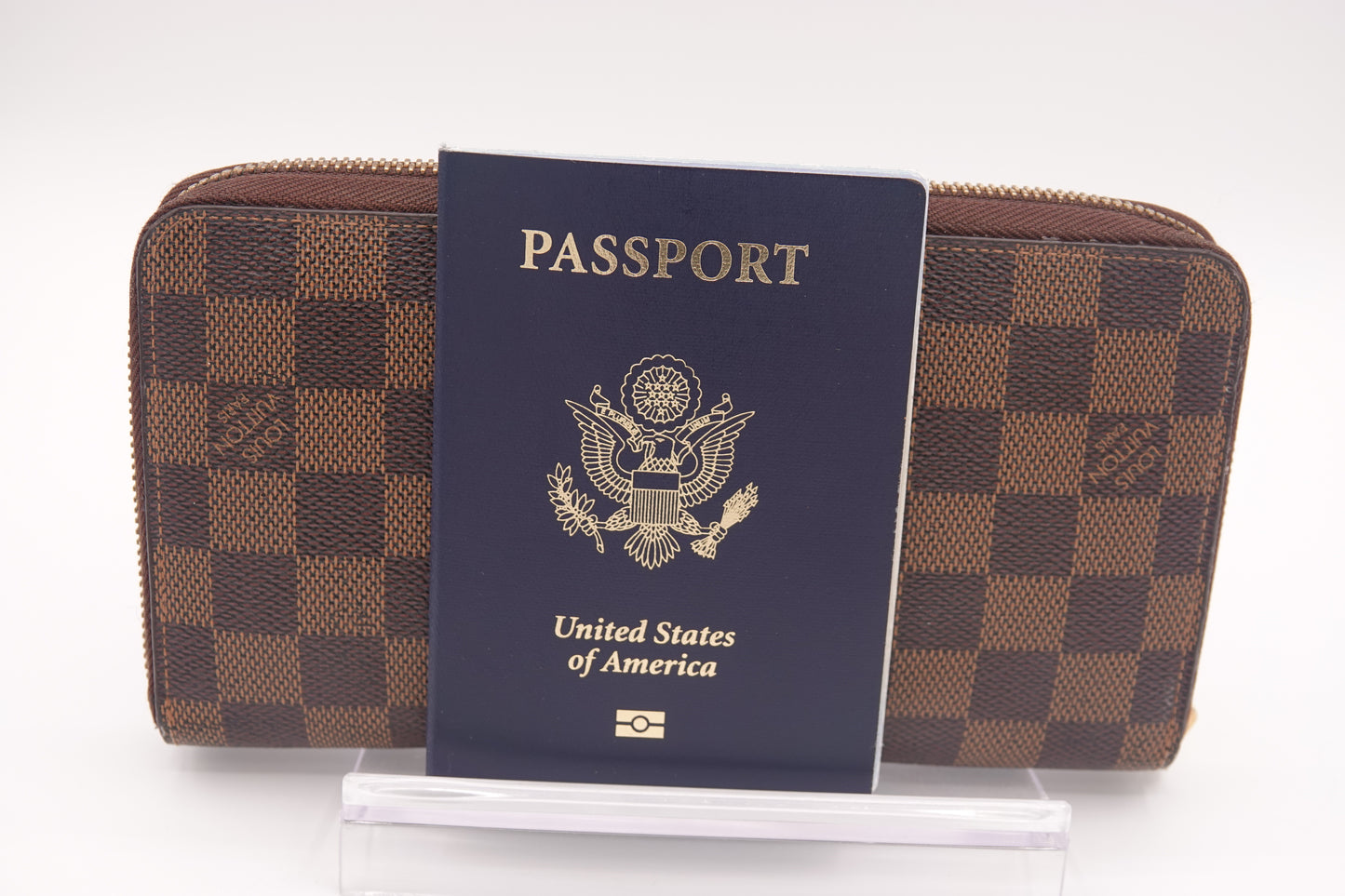 Brown checkered wallet with a US passport on a white background