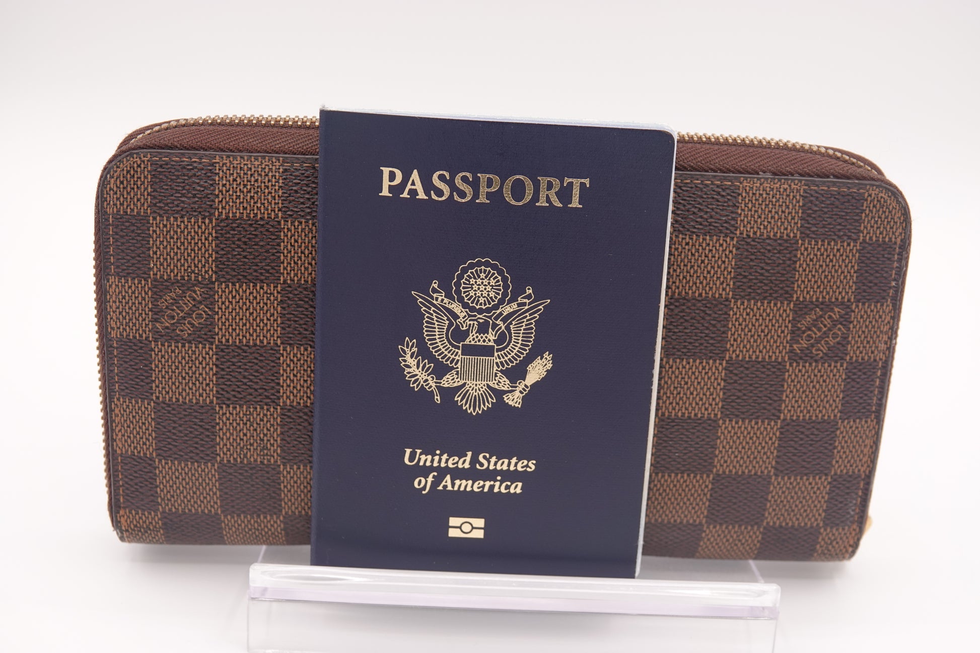 Brown checkered wallet with a US passport on a white background