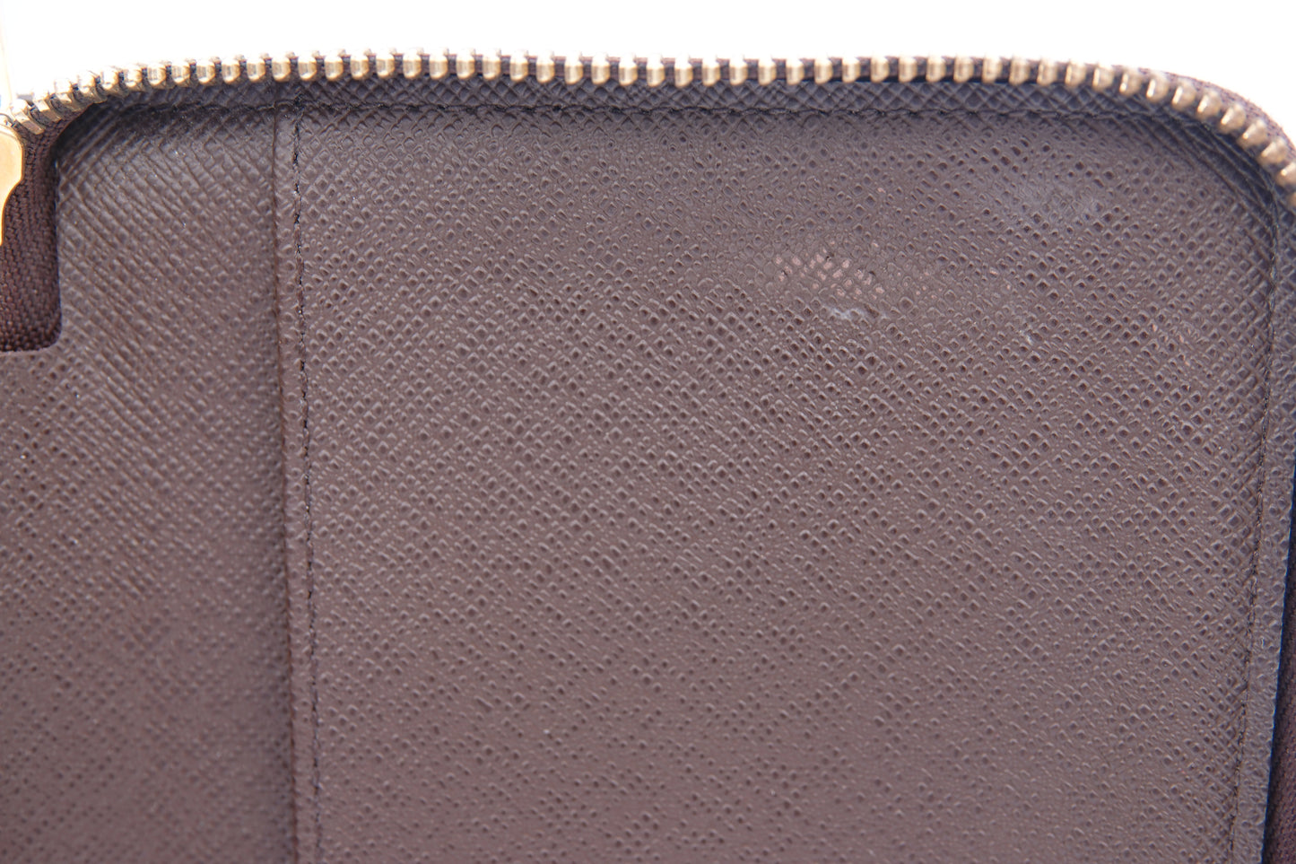 Close-up of a textured purple pouch with a zipper.