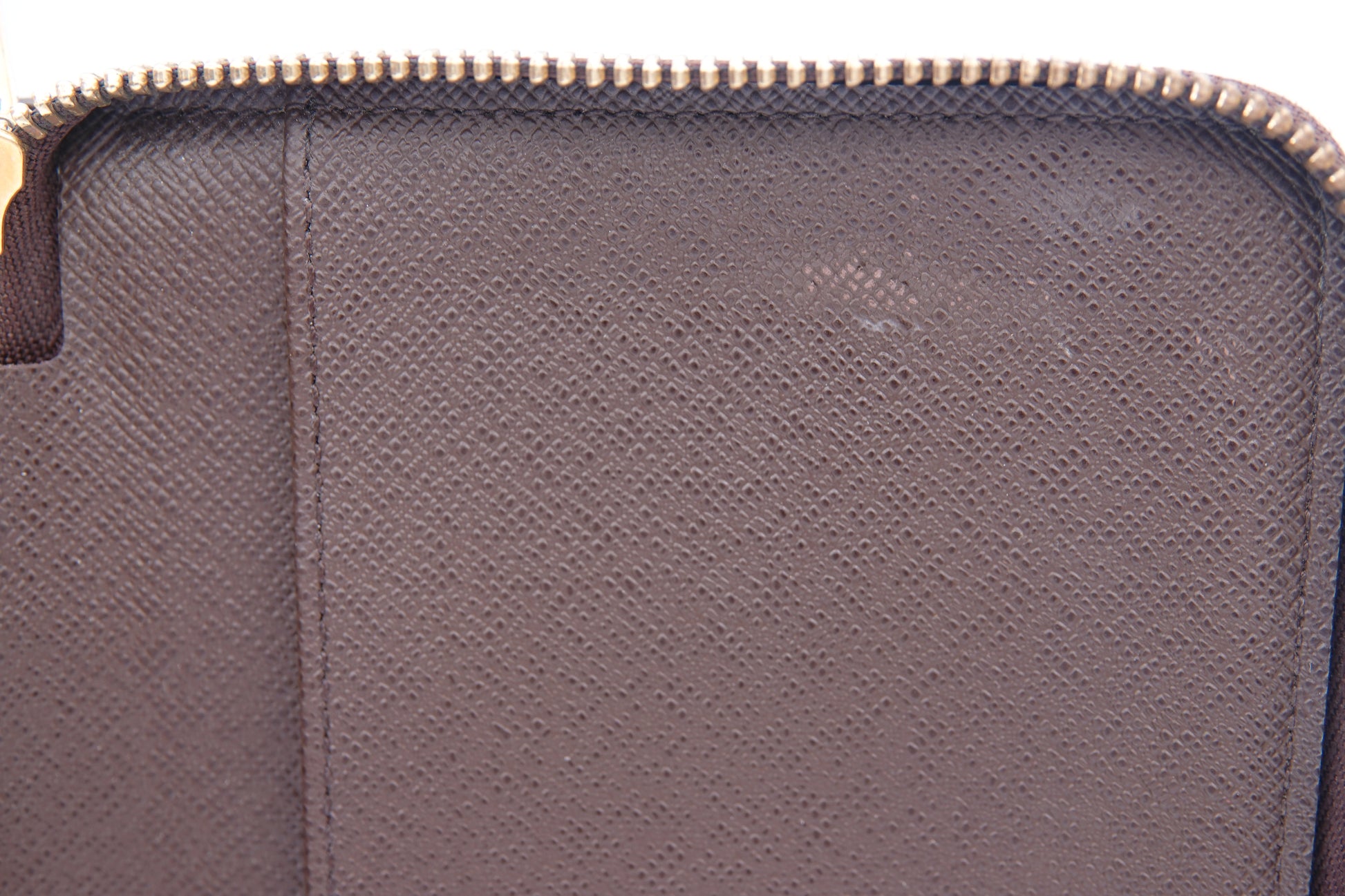 Close-up of a textured purple pouch with a zipper.