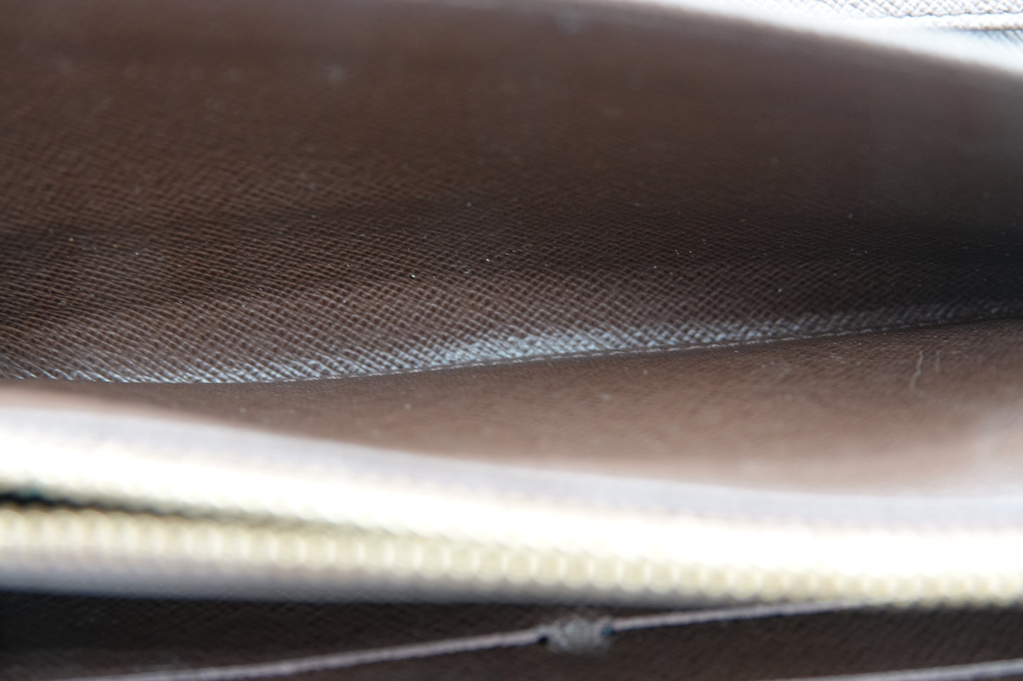 Close-up of a textured brown surface with a zipper