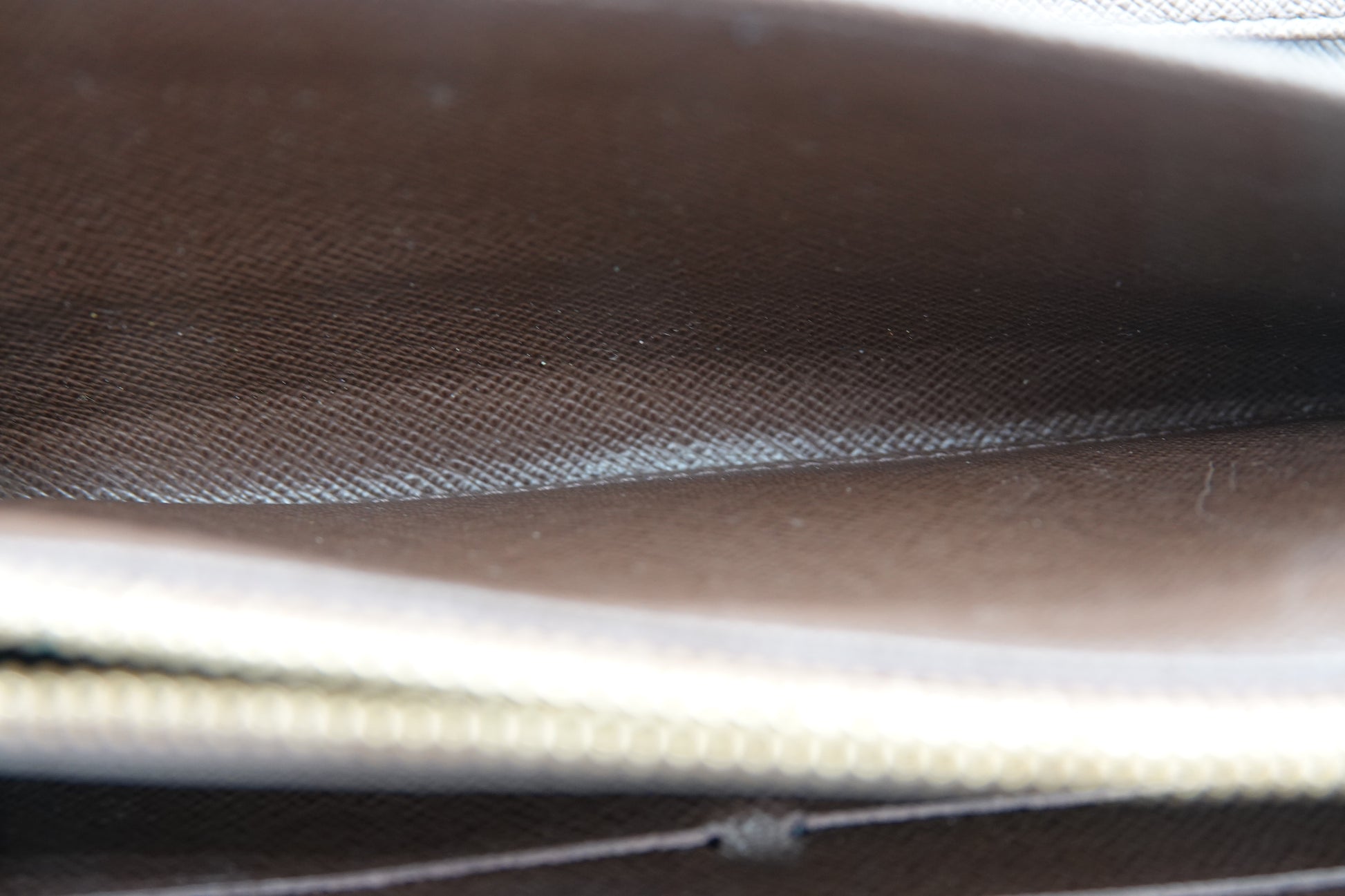Close-up of a textured brown surface with a zipper
