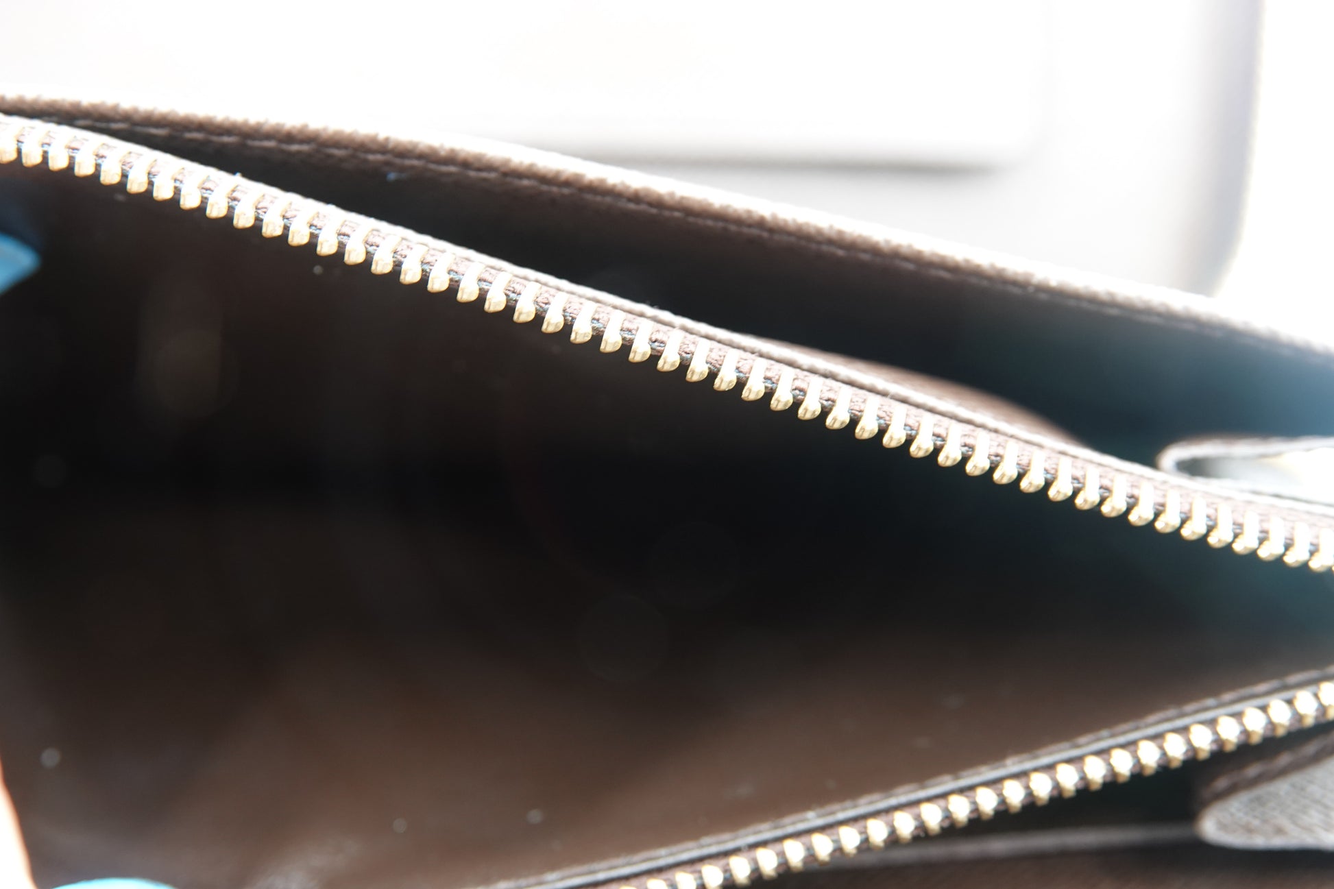 Close-up of a black leather bag with a zipper