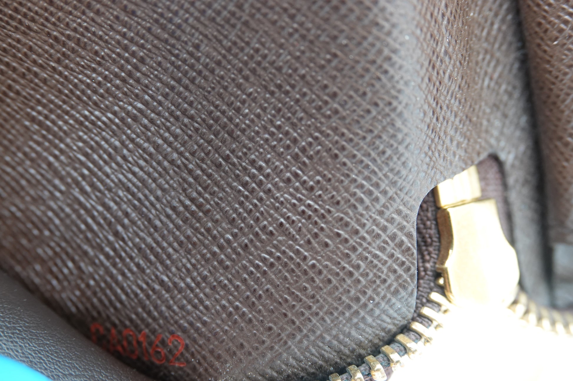 Close-up of a textured fabric surface with a zipper