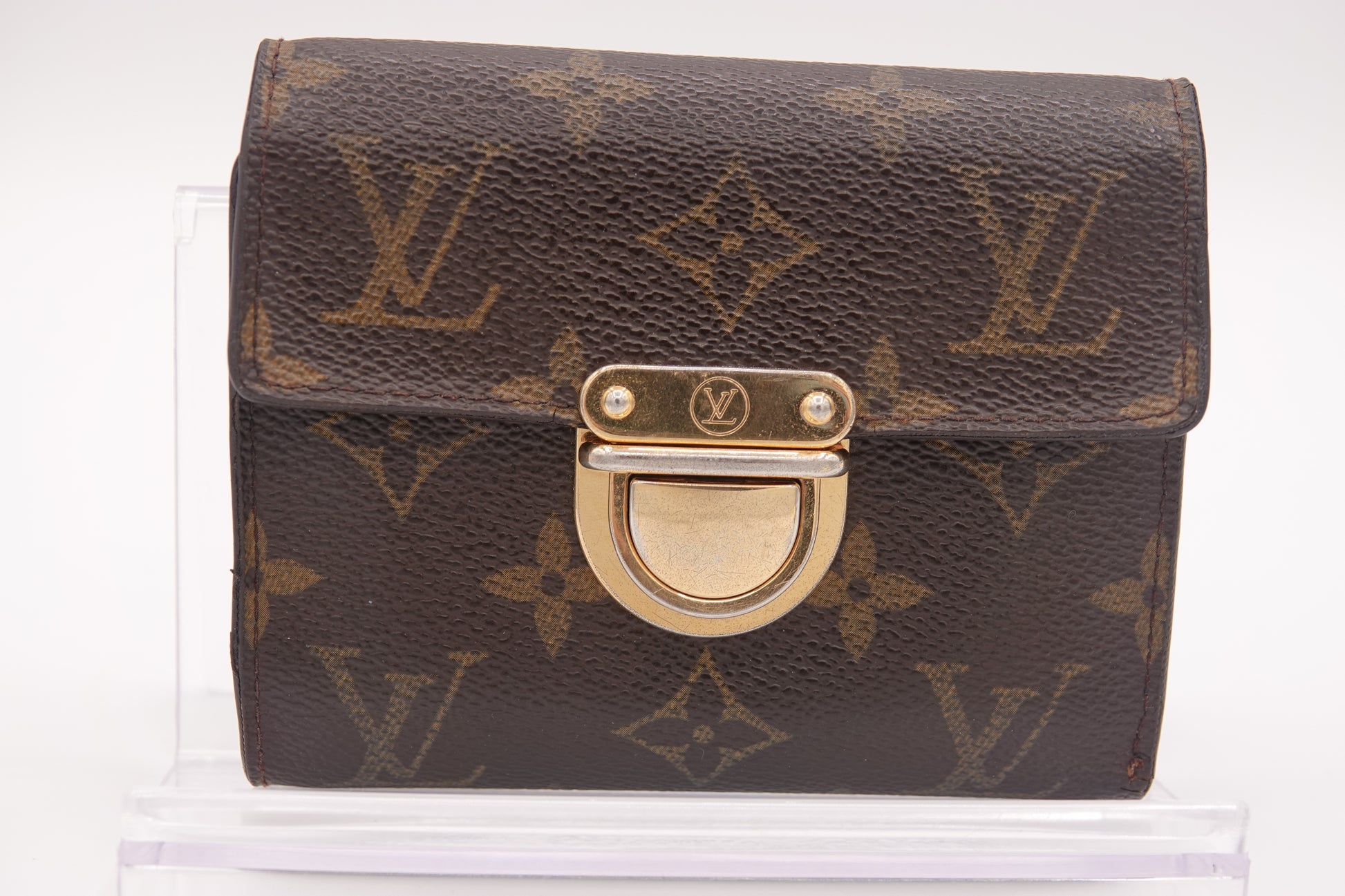 Designer handbag with monogram pattern on a white background