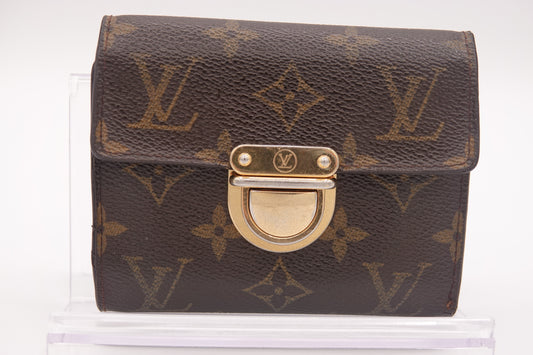 Designer handbag with monogram pattern on a white background