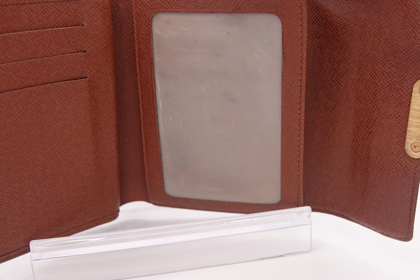 Brown leather wallet with a clear card holder on a white background