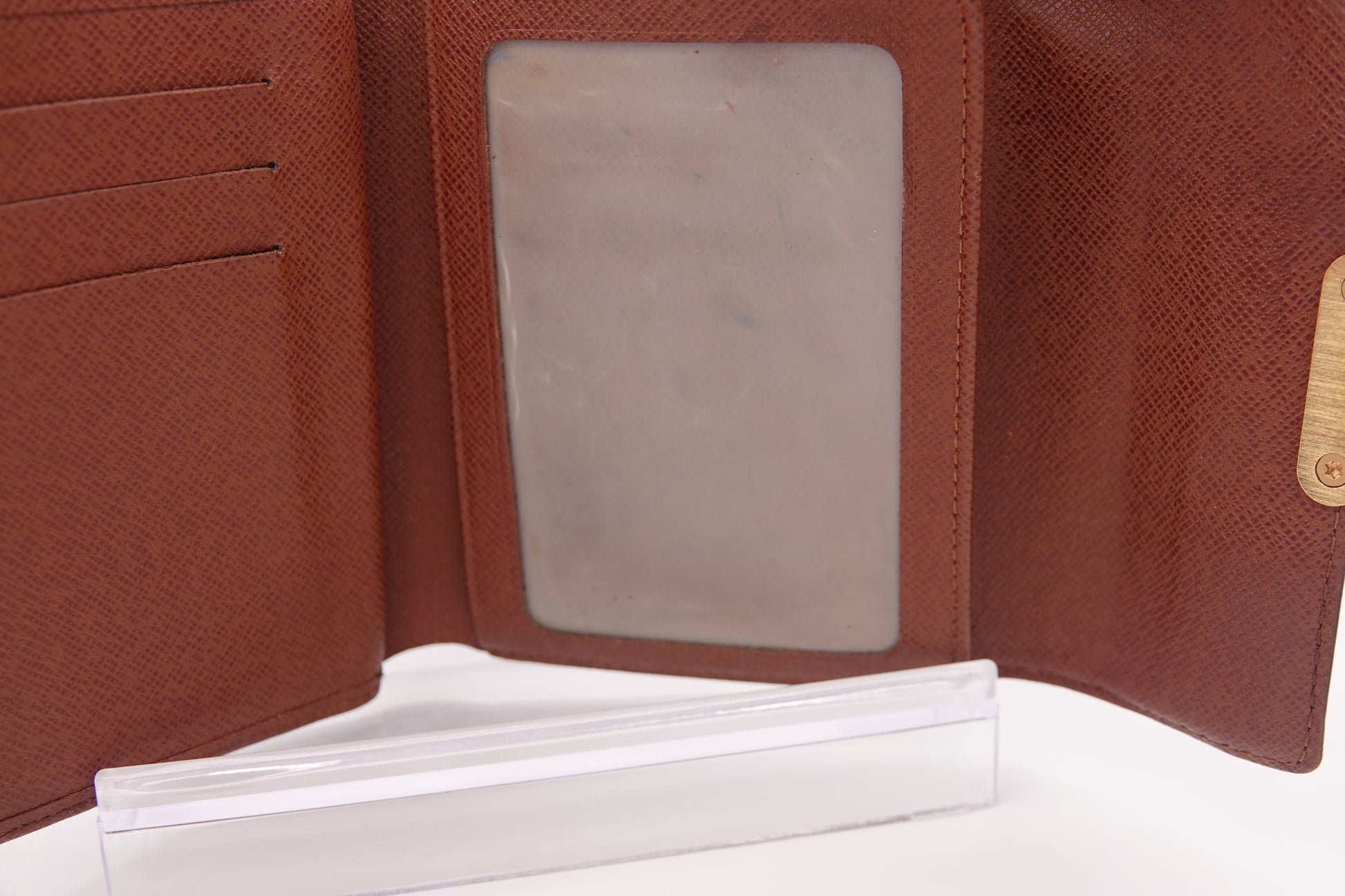 Brown leather wallet with a clear card holder on a white background