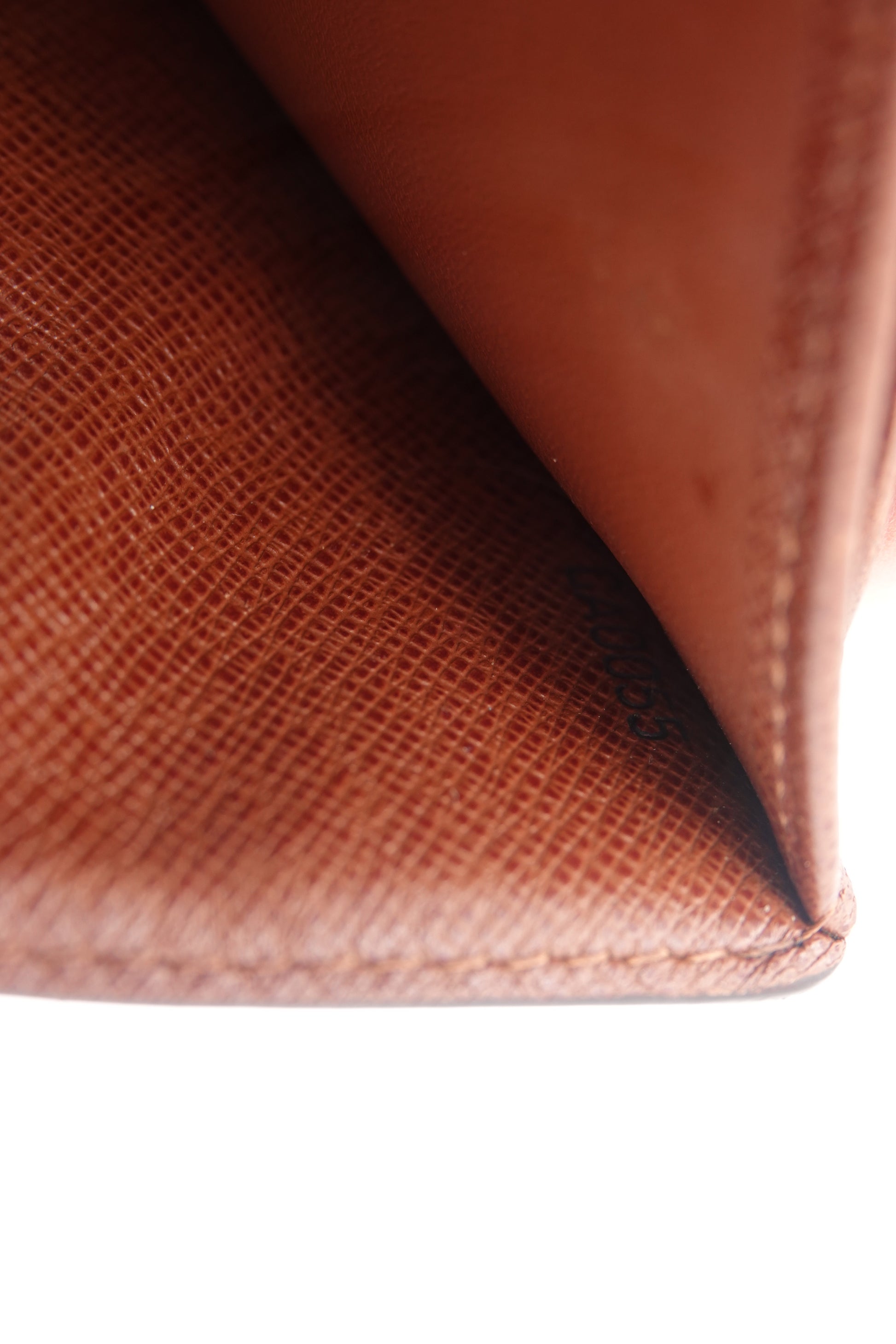 Close-up of a brown leather wallet with visible texture.