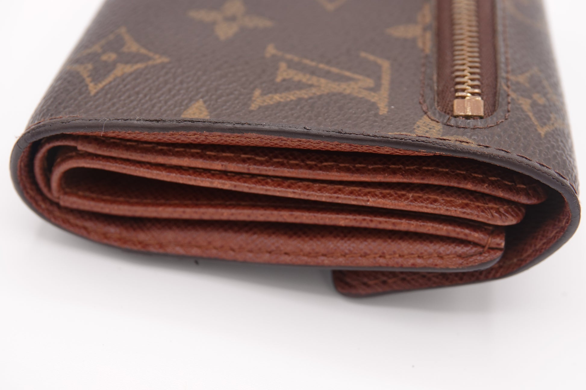 Brown wallet with visible brand logo on a white background