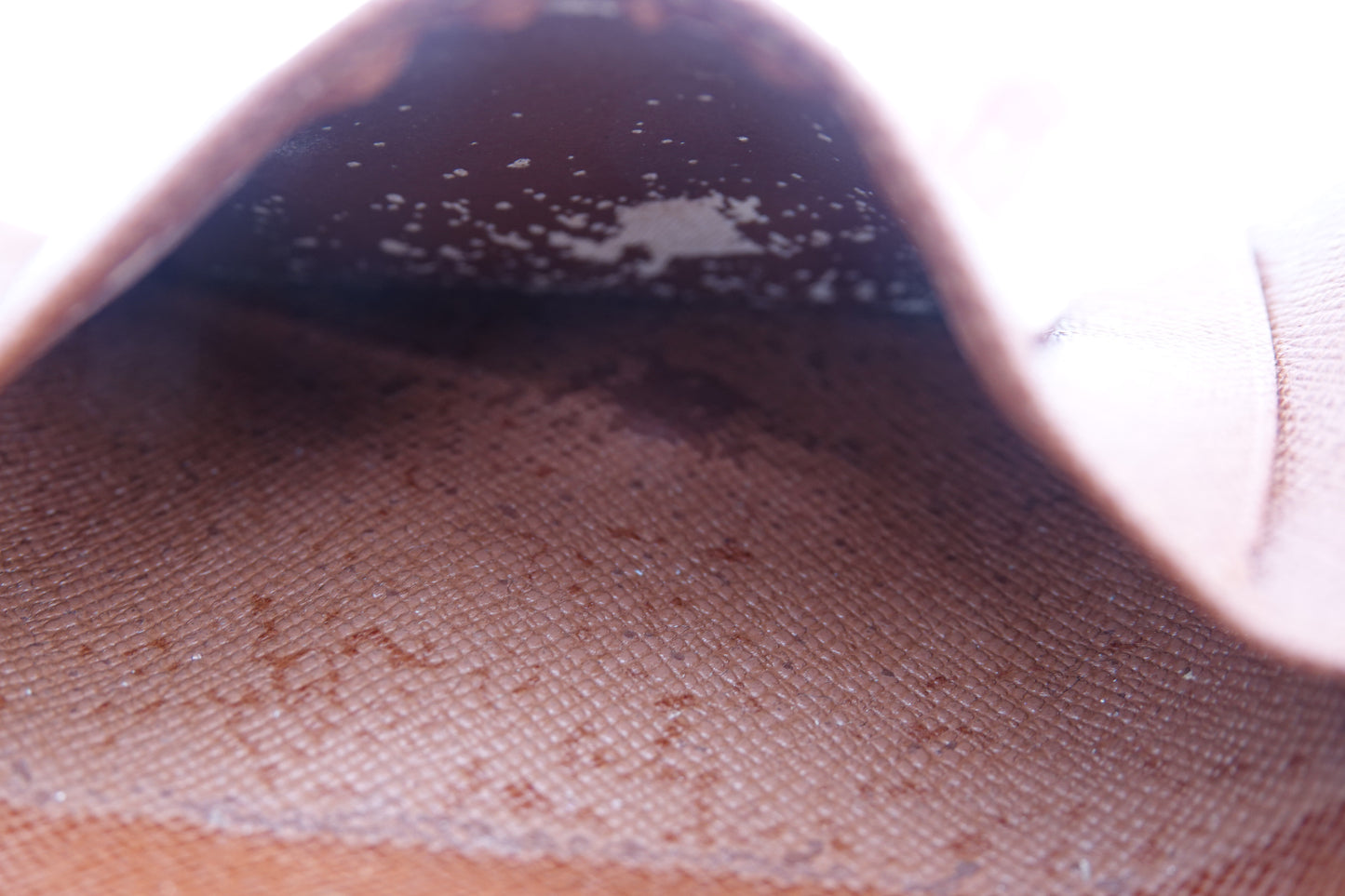 Close-up of a shoe with visible dirt and stains on a white background