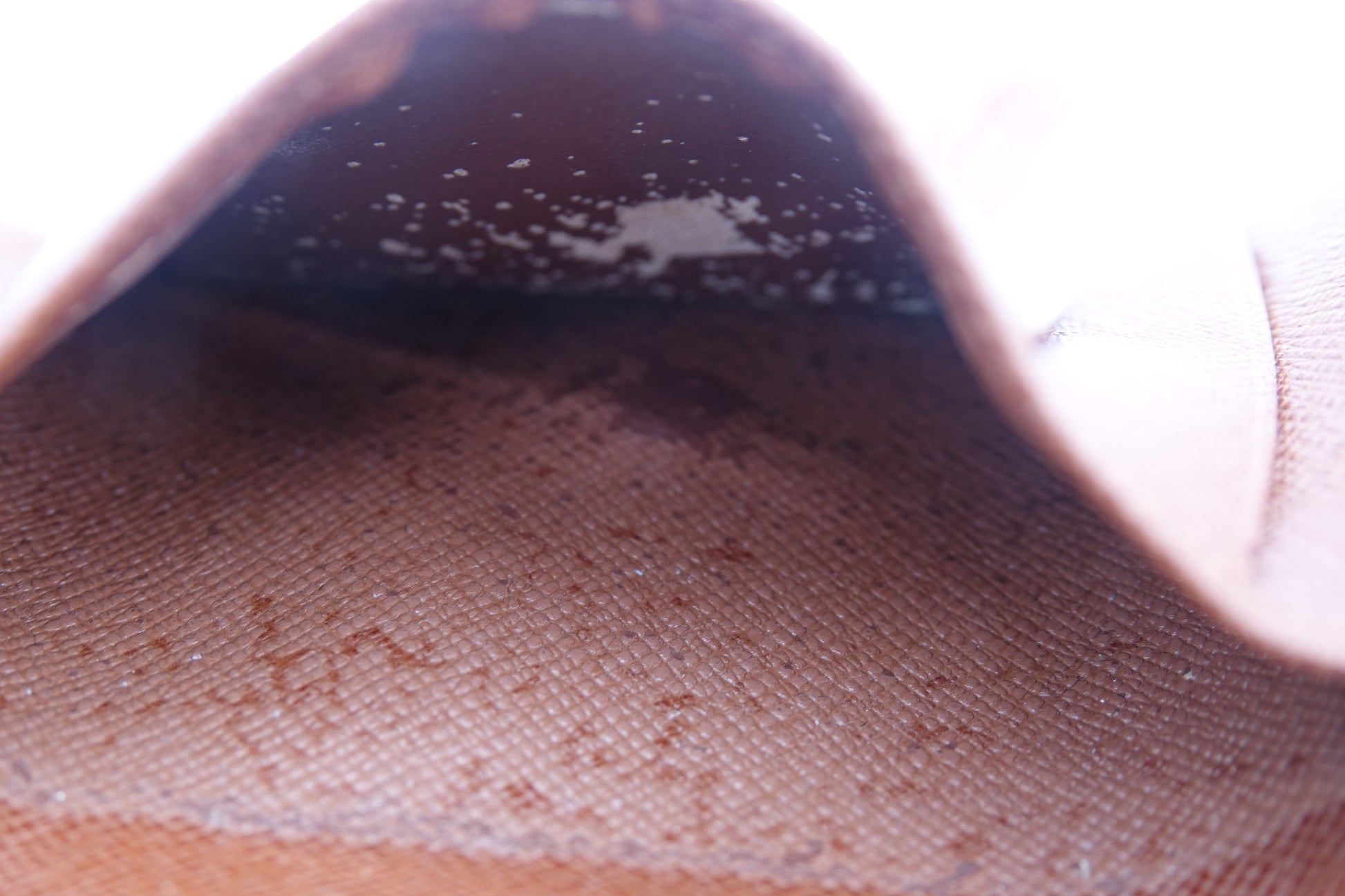 Close-up of a shoe with visible dirt and stains on a white background