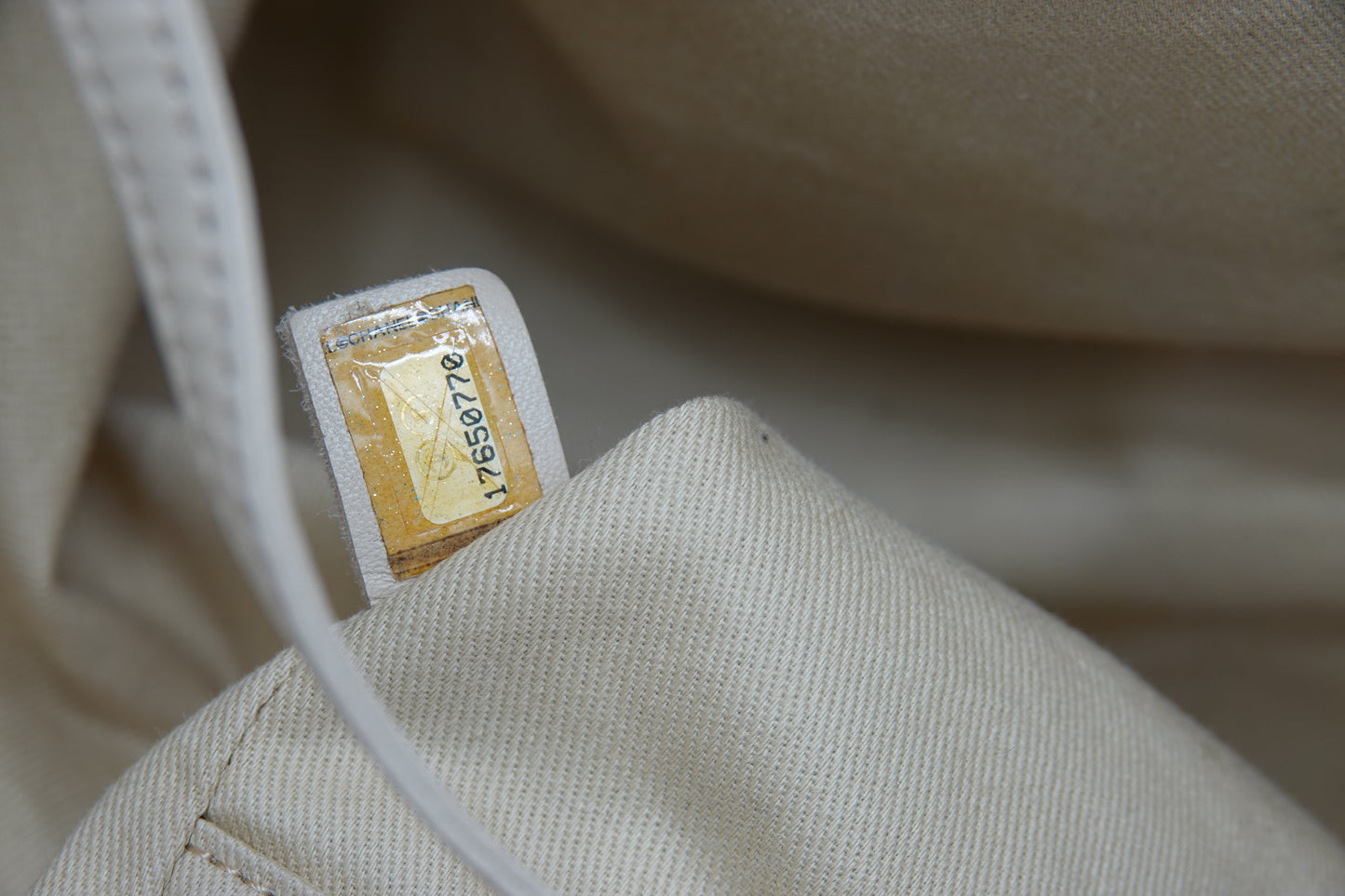 Close-up of a beige fabric with a label on a blurred background