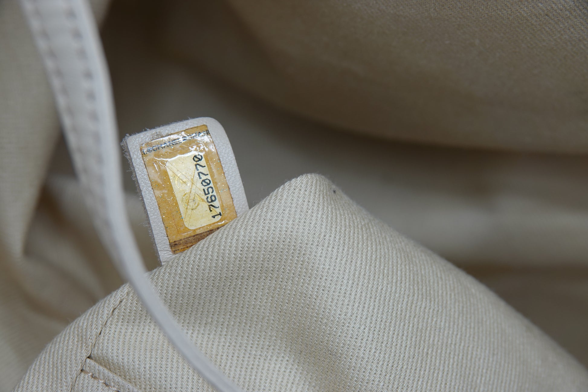 Close-up of a beige fabric with a label on a blurred background