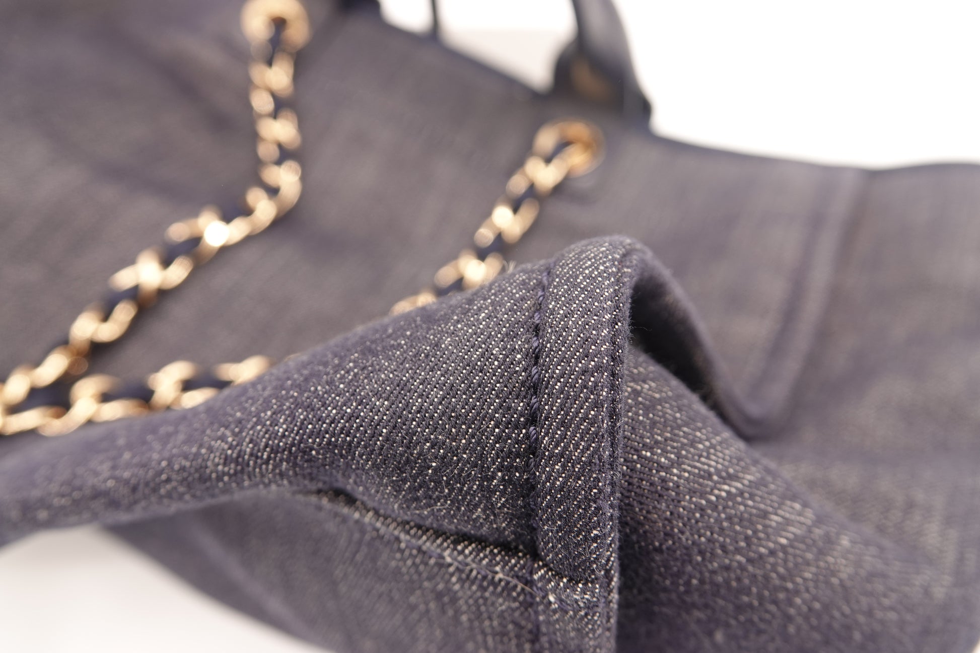 Close-up of a dark fabric with gold chain detail