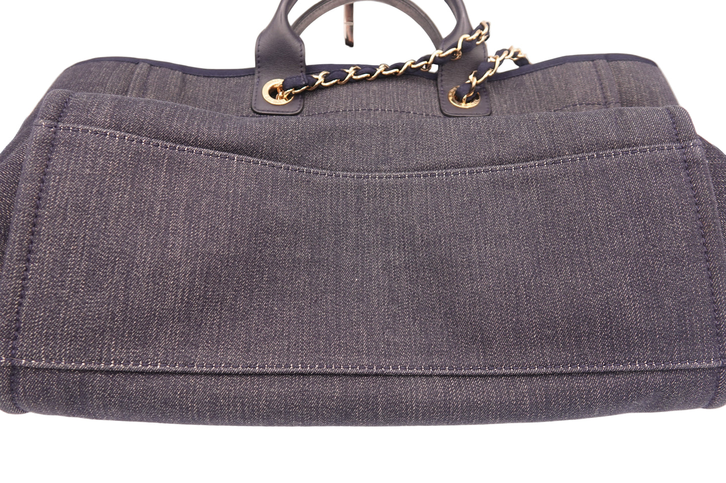 Gray handbag with gold chain handle on a white background