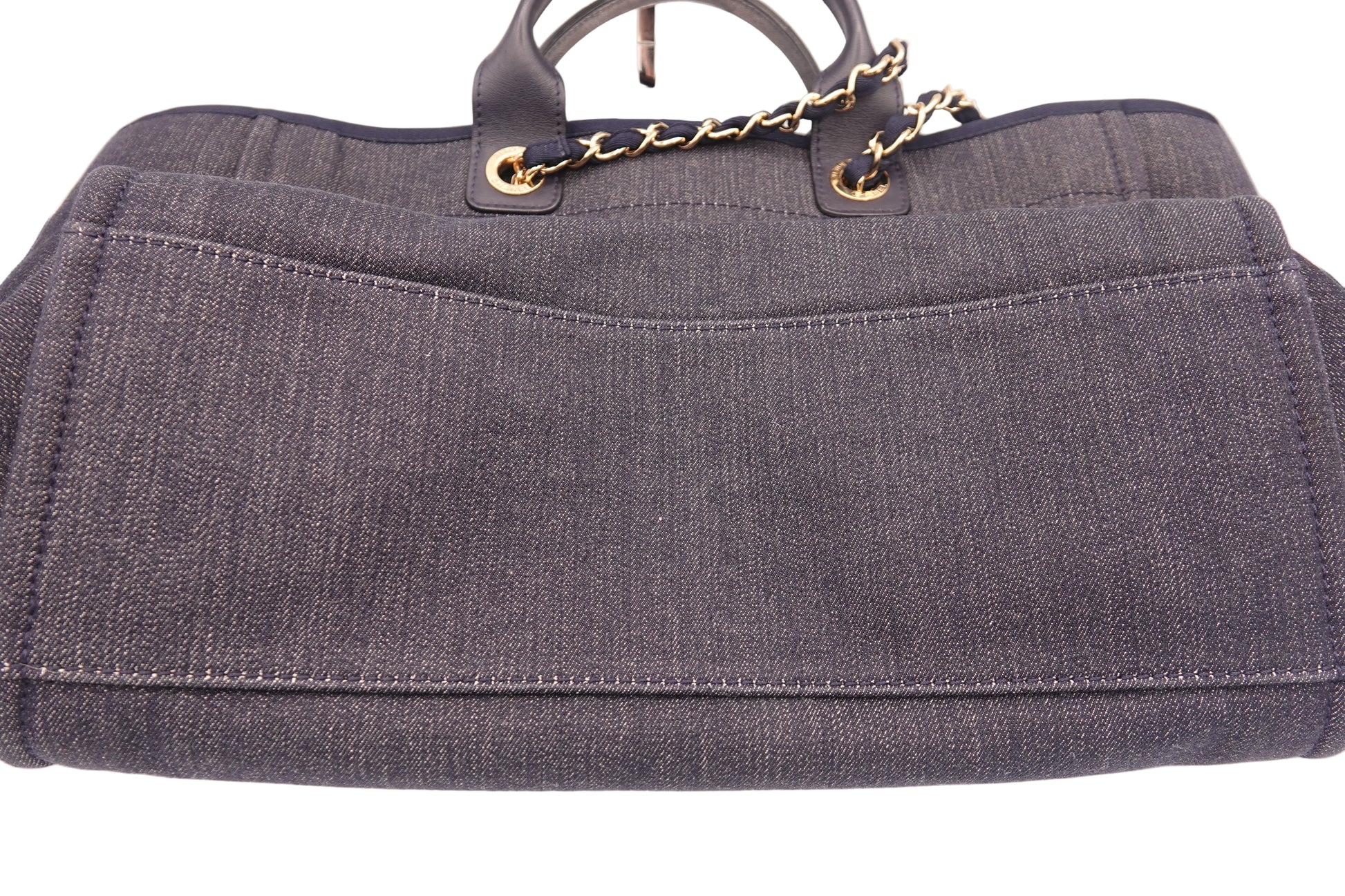 Gray handbag with gold chain handle on a white background