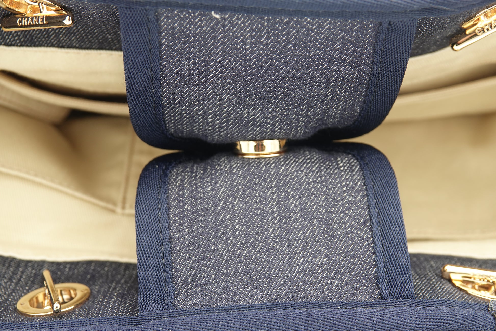 Close-up of a blue textured handbag with gold hardware