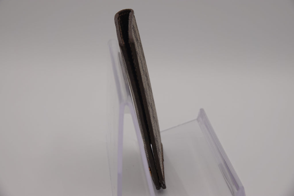 Black rectangular object on a clear stand against a white background