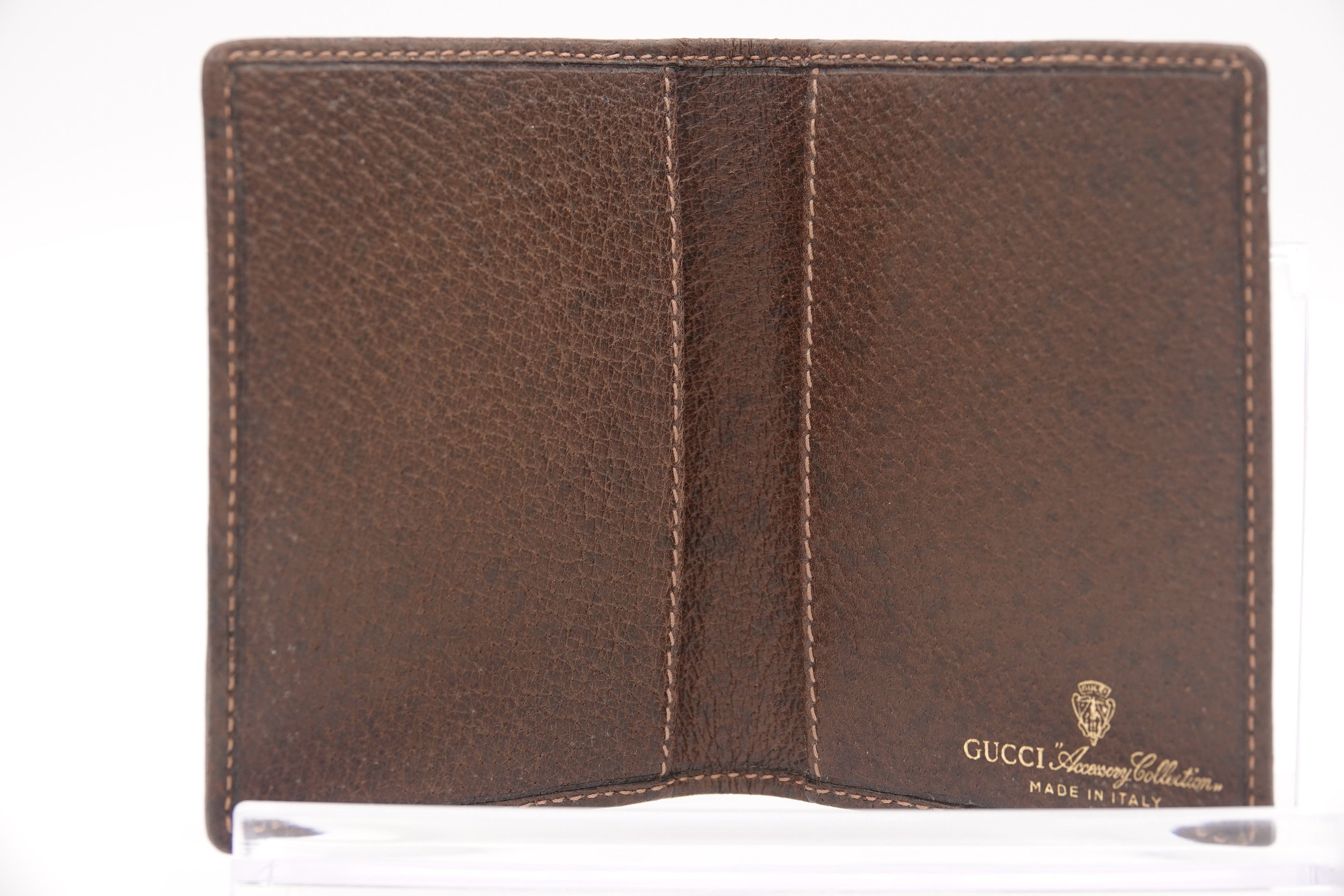 Brown leather wallet with Gucci logo on a white background