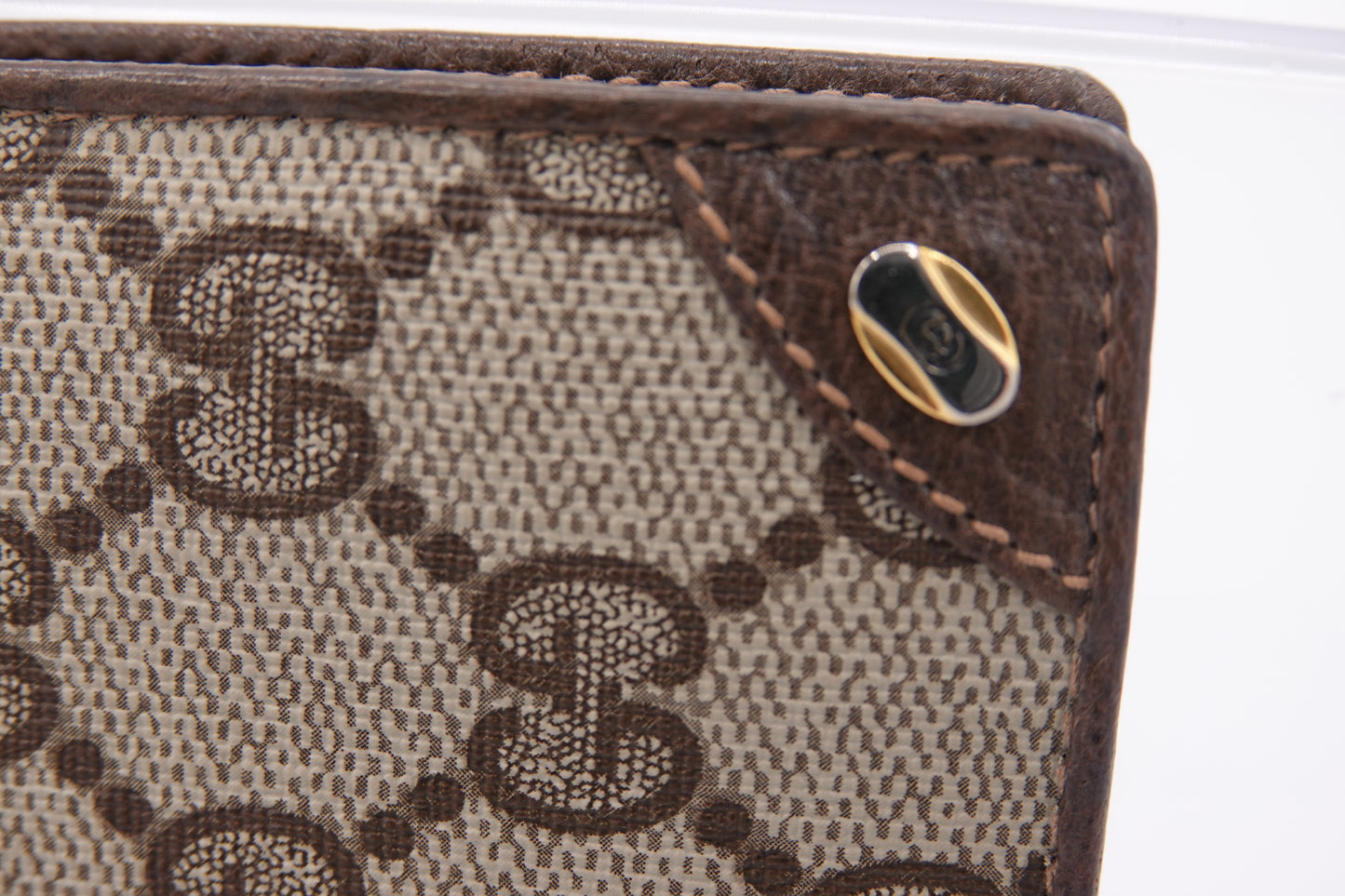Close-up of a Gucci wallet with brown monogram pattern